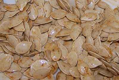 Spread the seeds on a cookie sheet and season them